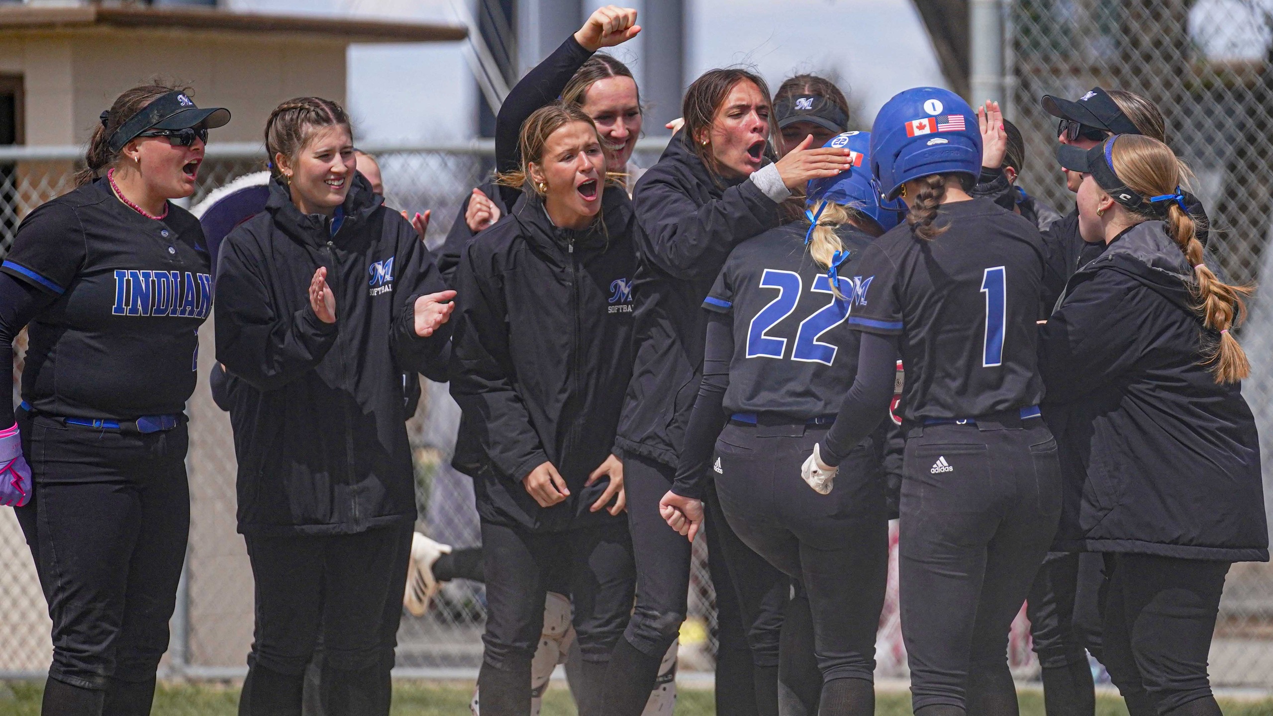 College softball players celebrate.